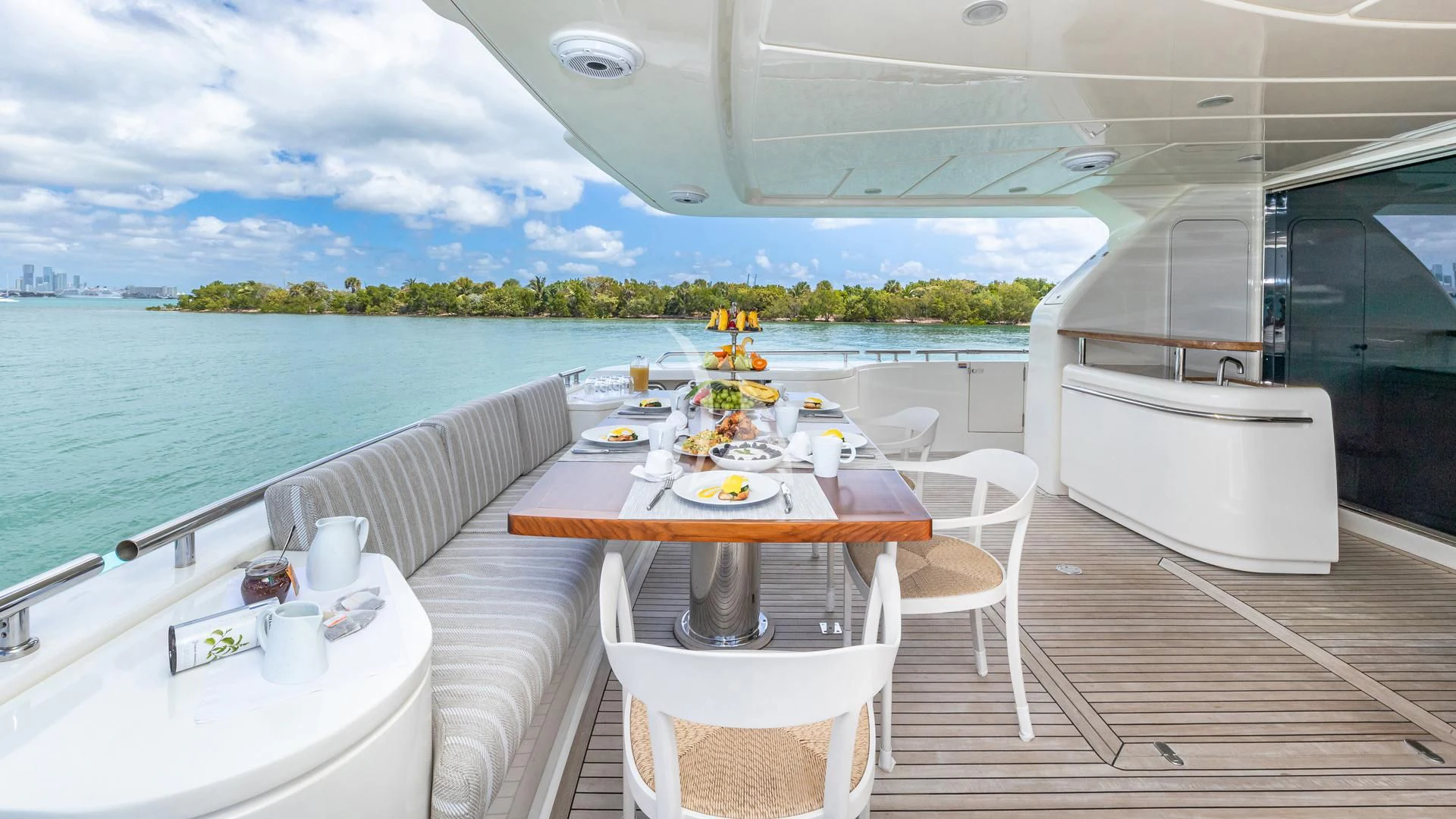 a table on a deck overlooking a body of water aboard HOYA SAXA Yacht for Sale