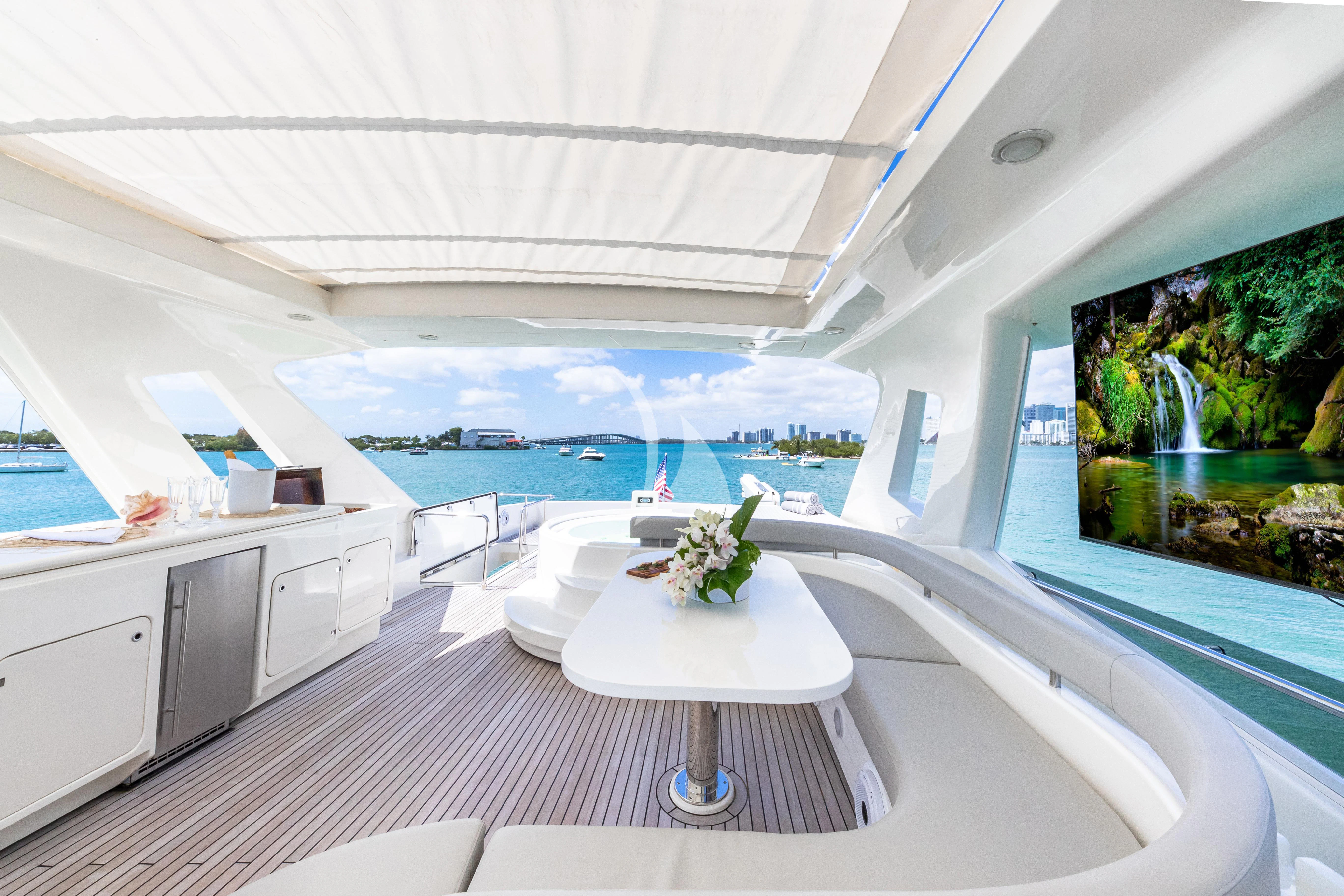a white table with a white table and chairs in a room with a large window and a view aboard HOYA SAXA Yacht for Sale