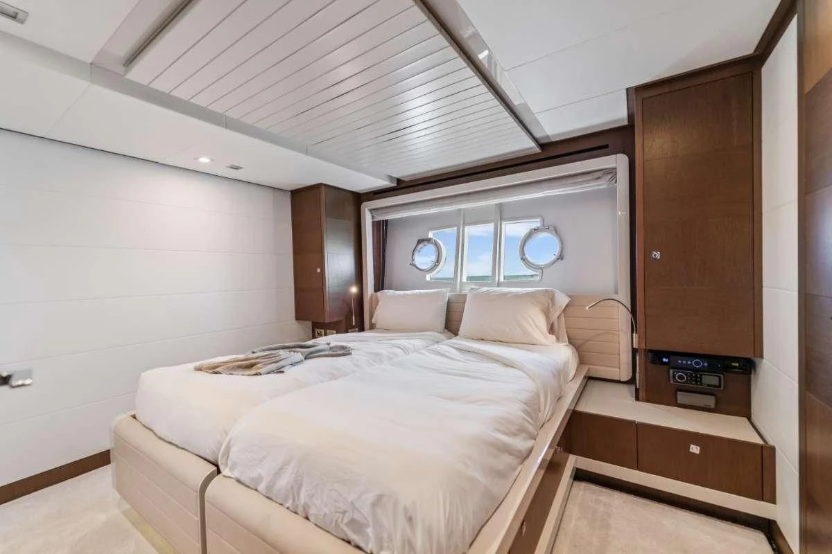 a bedroom with a bed and a dresser aboard HOYA SAXA Yacht for Sale