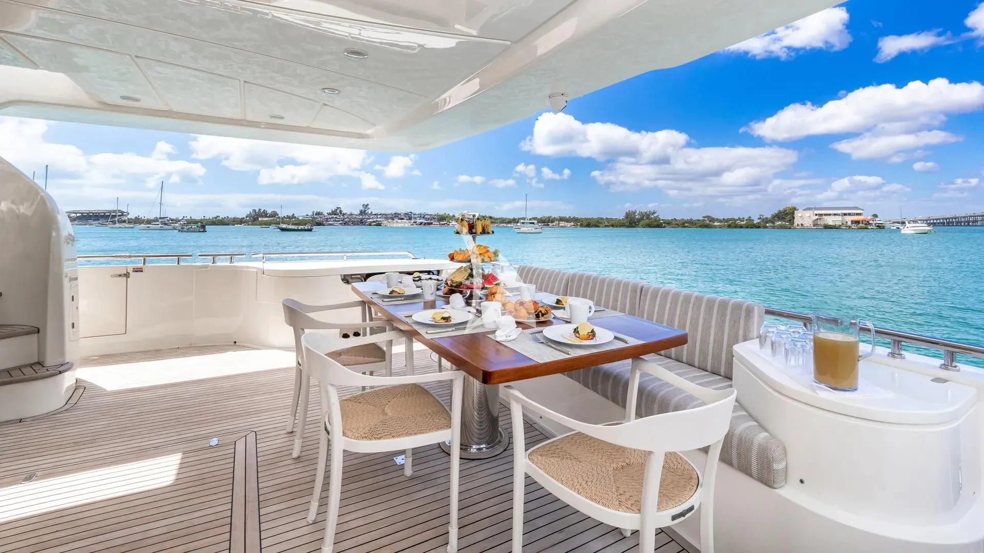 a table and chairs on a deck overlooking a body of water aboard HOYA SAXA Yacht for Sale