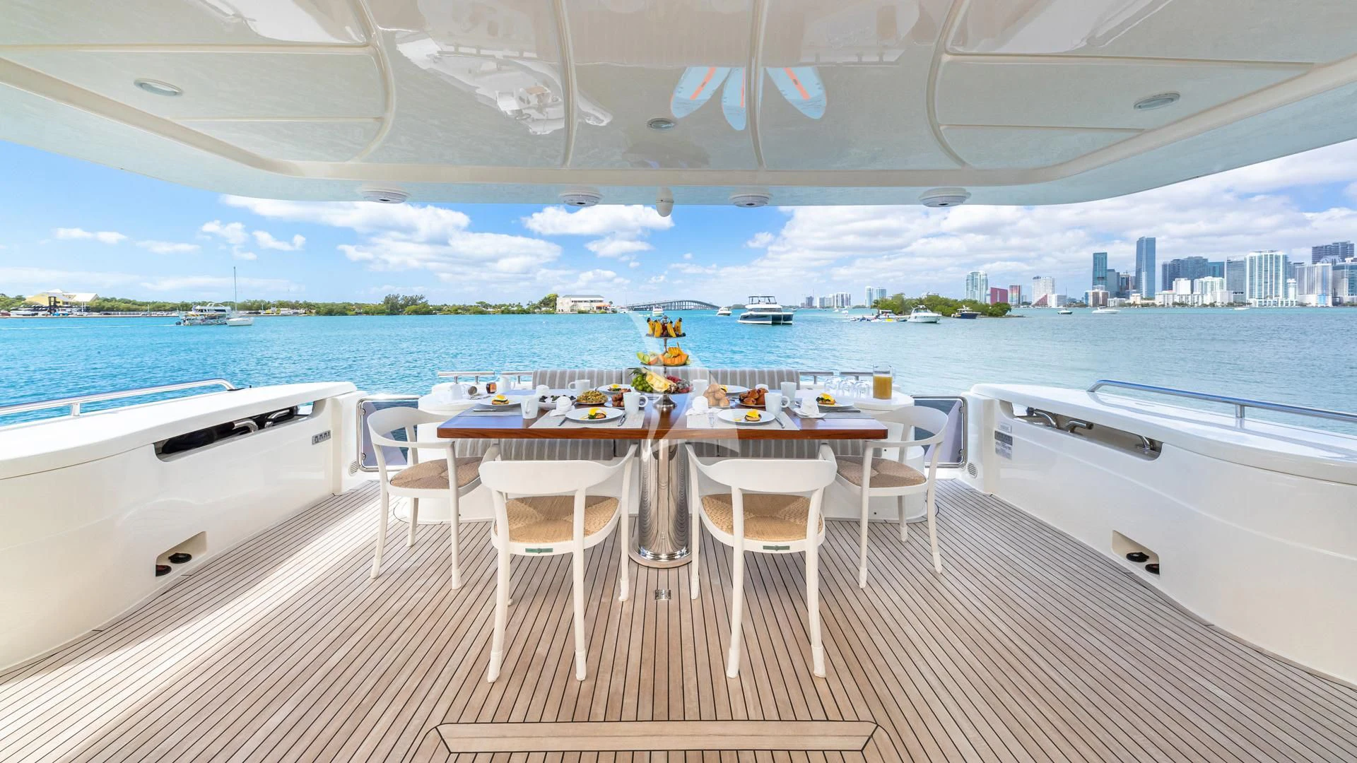 a room with a table and chairs on a deck overlooking a body of water aboard HOYA SAXA Yacht for Sale
