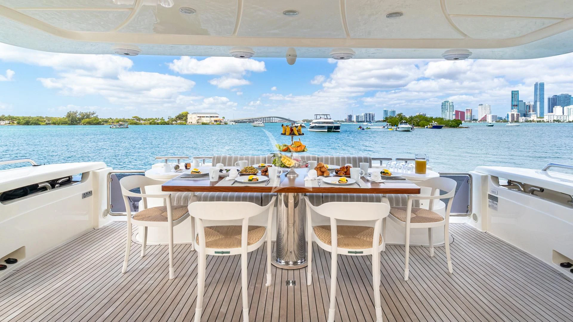 a table set for a meal on a deck overlooking a large body of water aboard HOYA SAXA Yacht for Sale