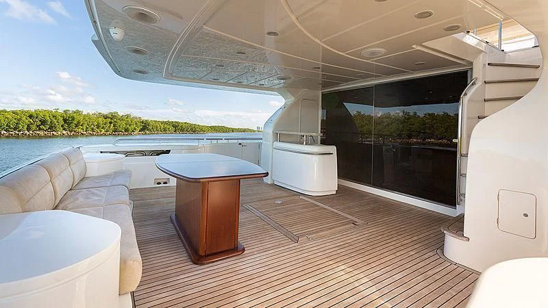 a room with a table and a couch aboard HOYA SAXA Yacht for Sale
