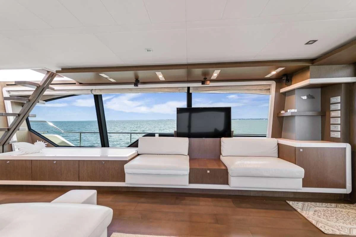 a room with a couch and a tv on the wall aboard HOYA SAXA Yacht for Sale