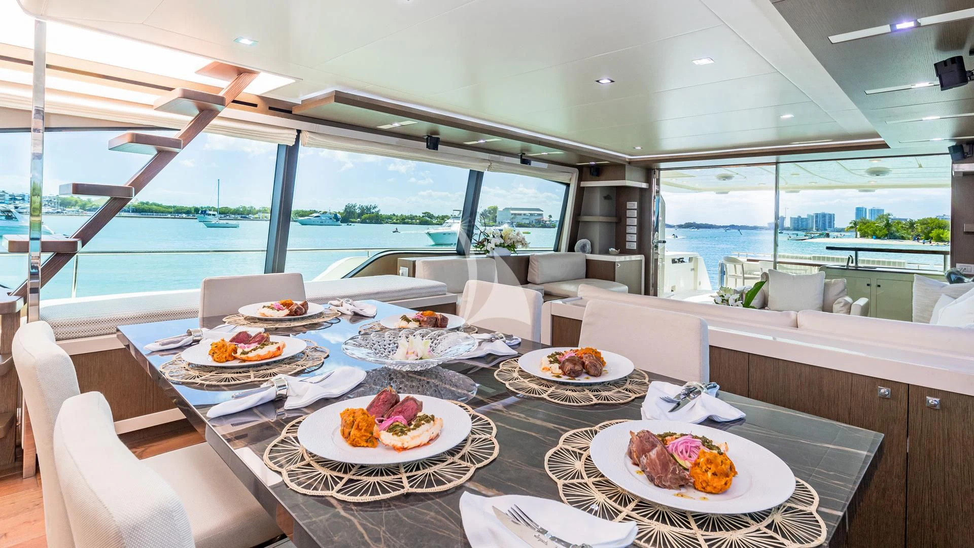 a table with plates of food on it aboard HOYA SAXA Yacht for Sale