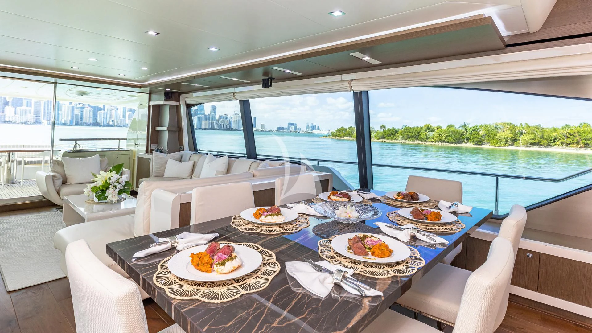 a table with plates and food on it aboard HOYA SAXA Yacht for Sale