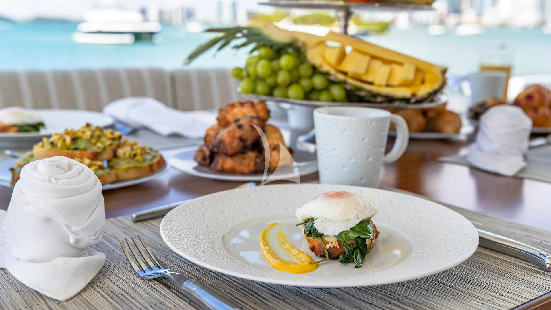 a table with plates of food and a cup of coffee aboard HOYA SAXA Yacht for Sale