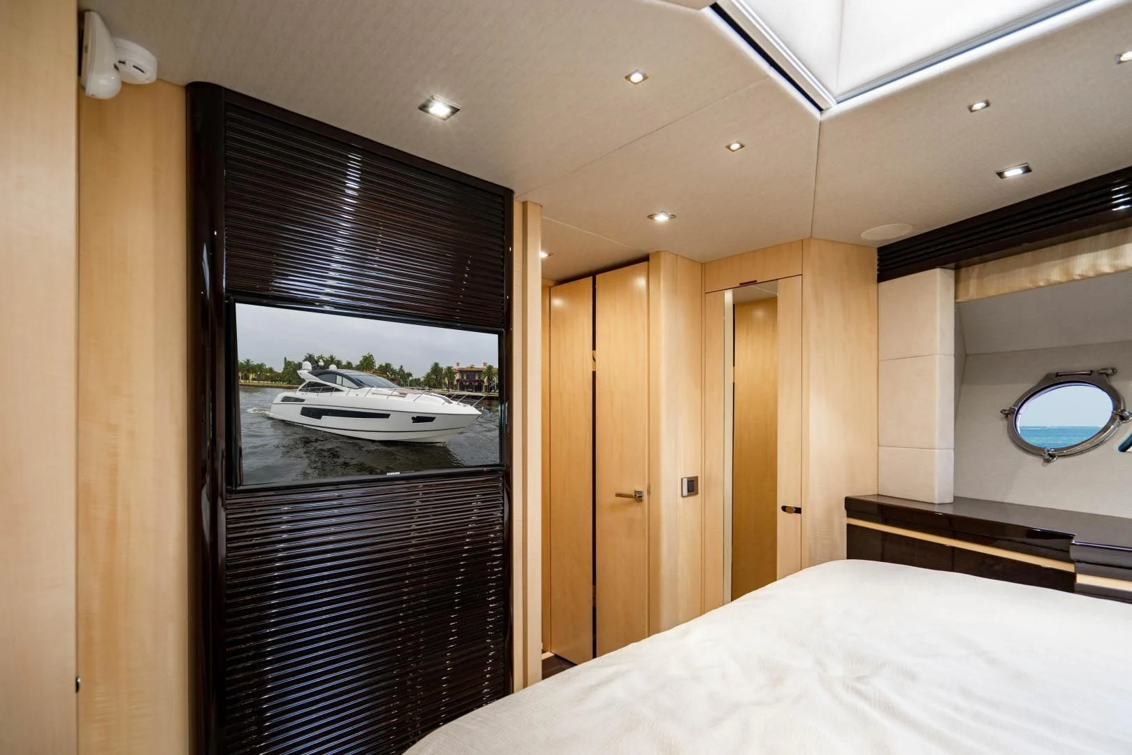 a room with a bed and a window aboard YOLO Yacht for Sale