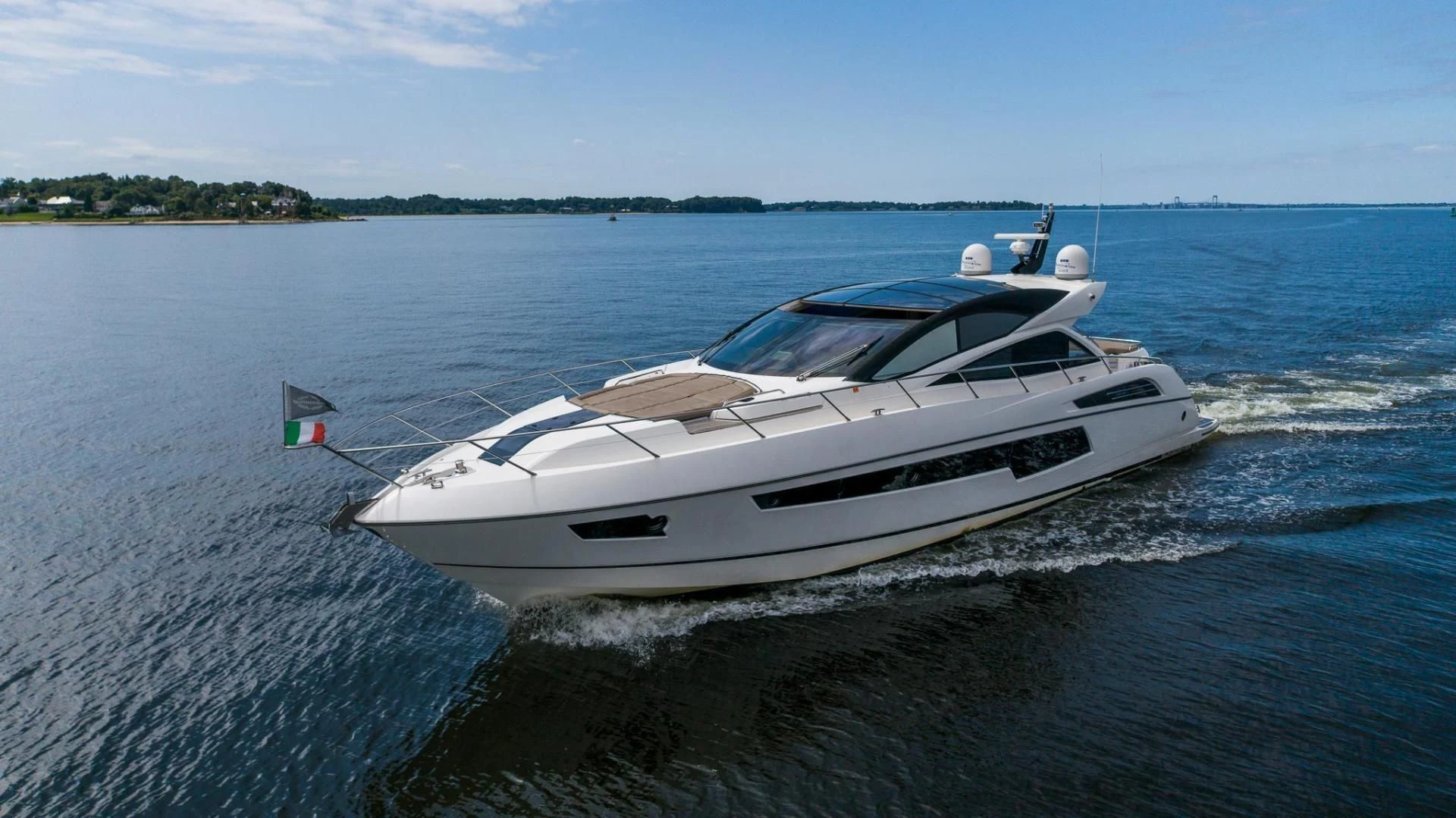 a white boat on the water aboard YOLO Yacht for Sale