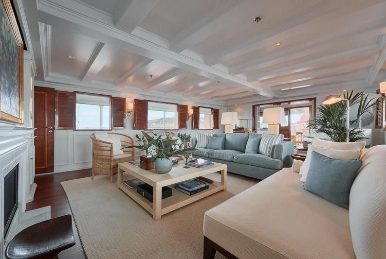 a living room with a couch and a coffee table aboard HAIDA 1929 Yacht for Sale