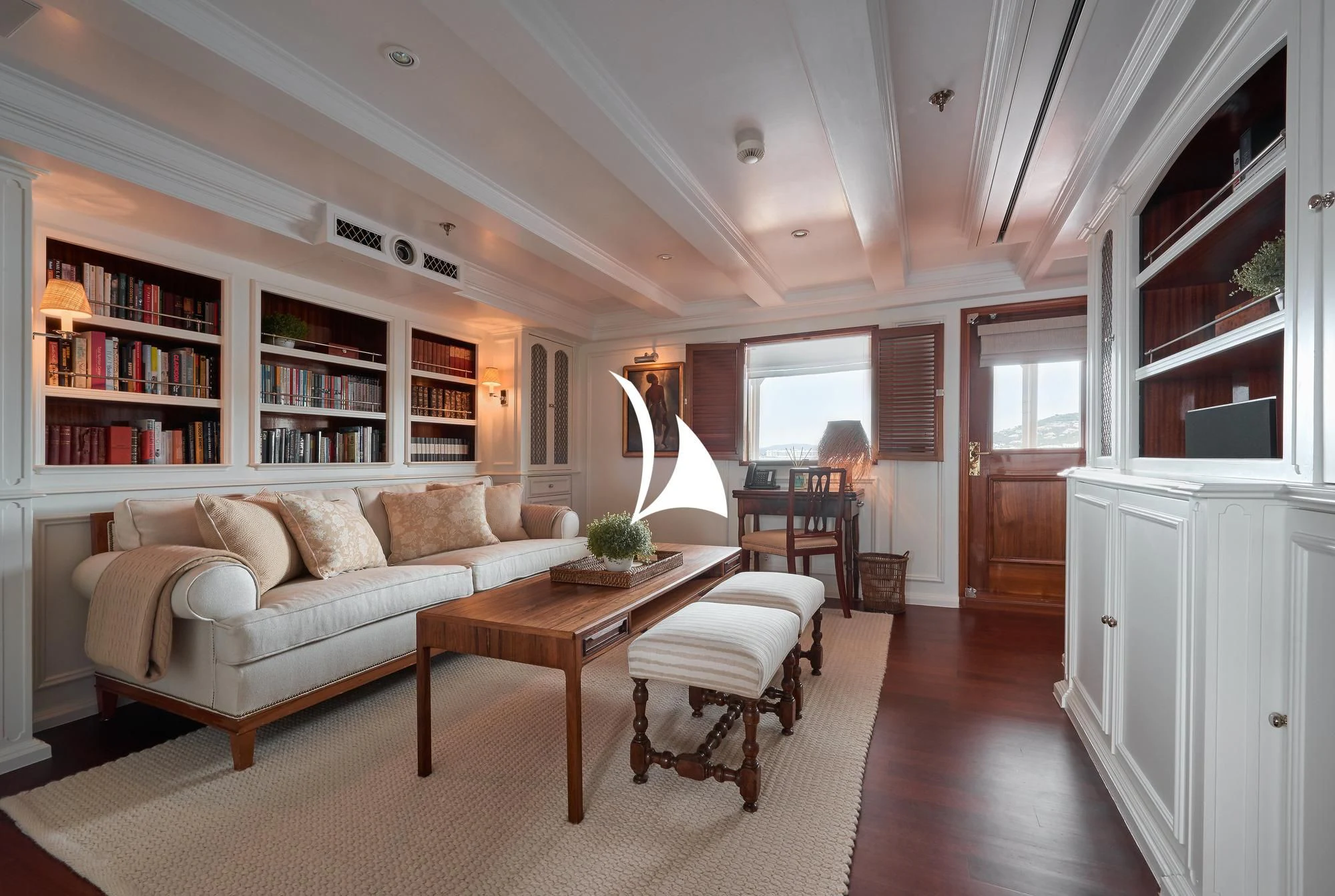 a living room with a couch and a table aboard HAIDA 1929 Yacht for Sale