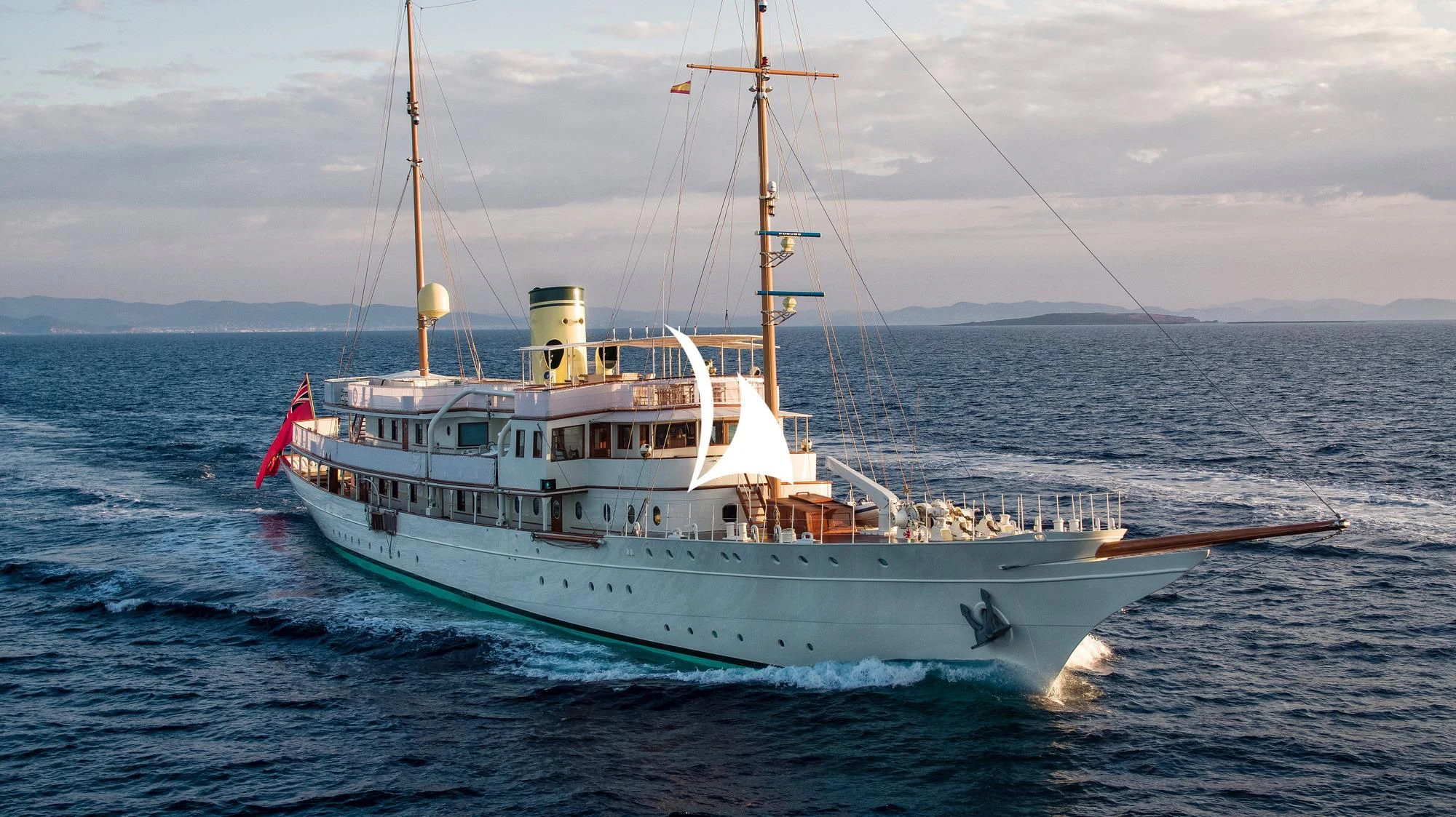 a large white boat in the water aboard HAIDA 1929 Yacht for Sale