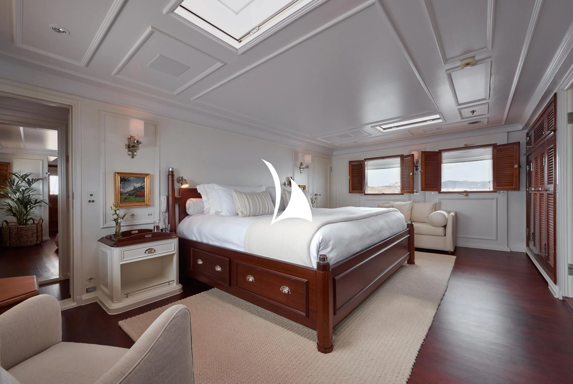 a large bedroom with a large bed aboard HAIDA 1929 Yacht for Sale