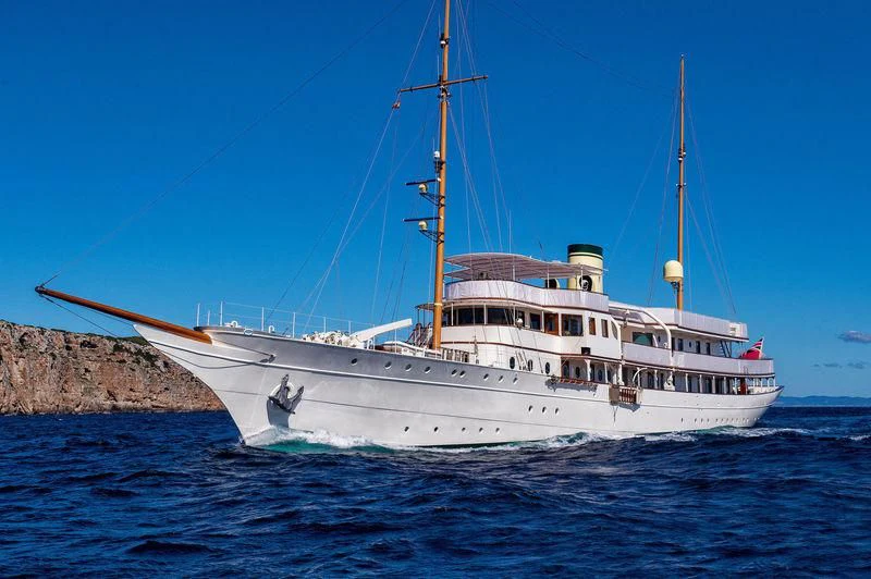 a large white boat in the water aboard HAIDA 1929 Yacht for Sale
