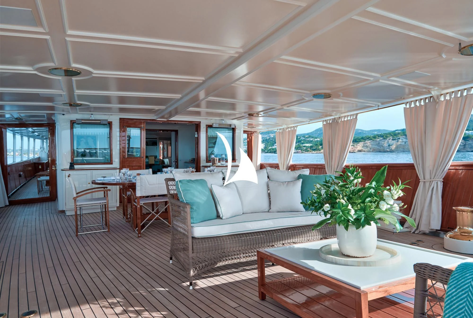 a living room with a couch and a table aboard HAIDA 1929 Yacht for Sale