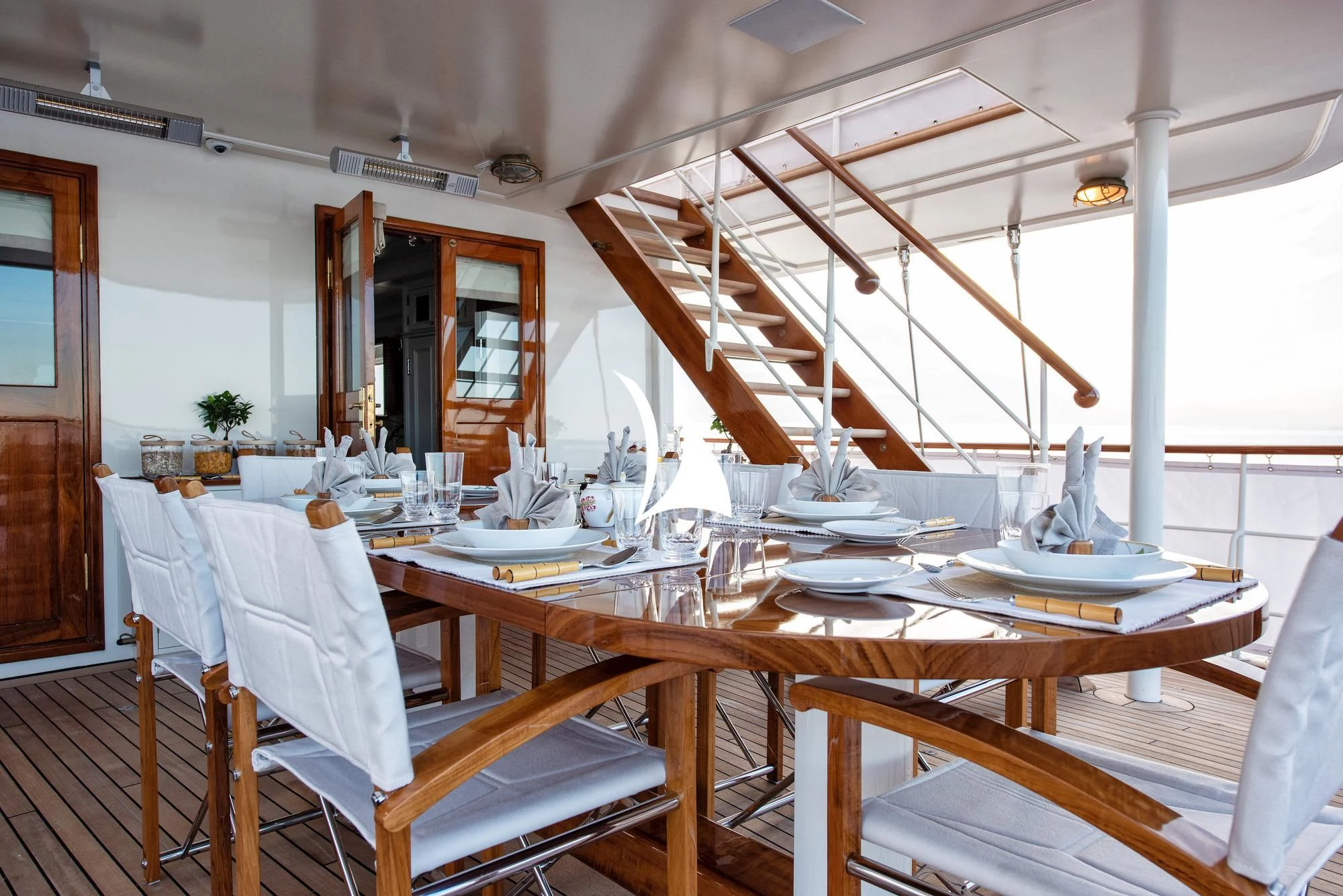 a dining room with tables and chairs aboard HAIDA 1929 Yacht for Sale