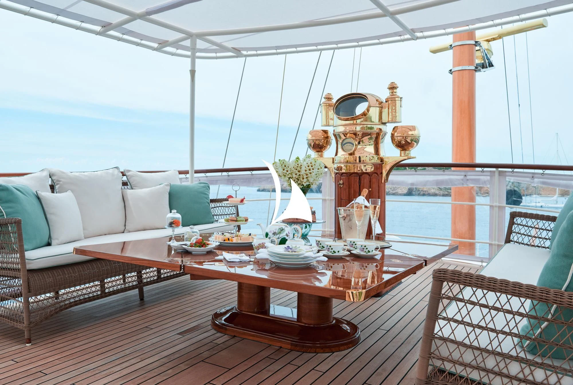 a living room with a large chandelier aboard HAIDA 1929 Yacht for Sale