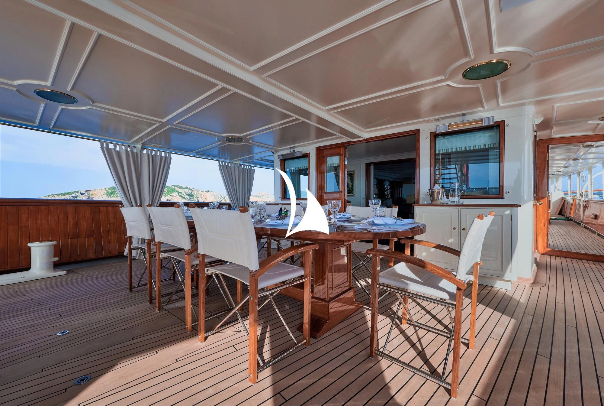 a room with tables and chairs aboard HAIDA 1929 Yacht for Sale