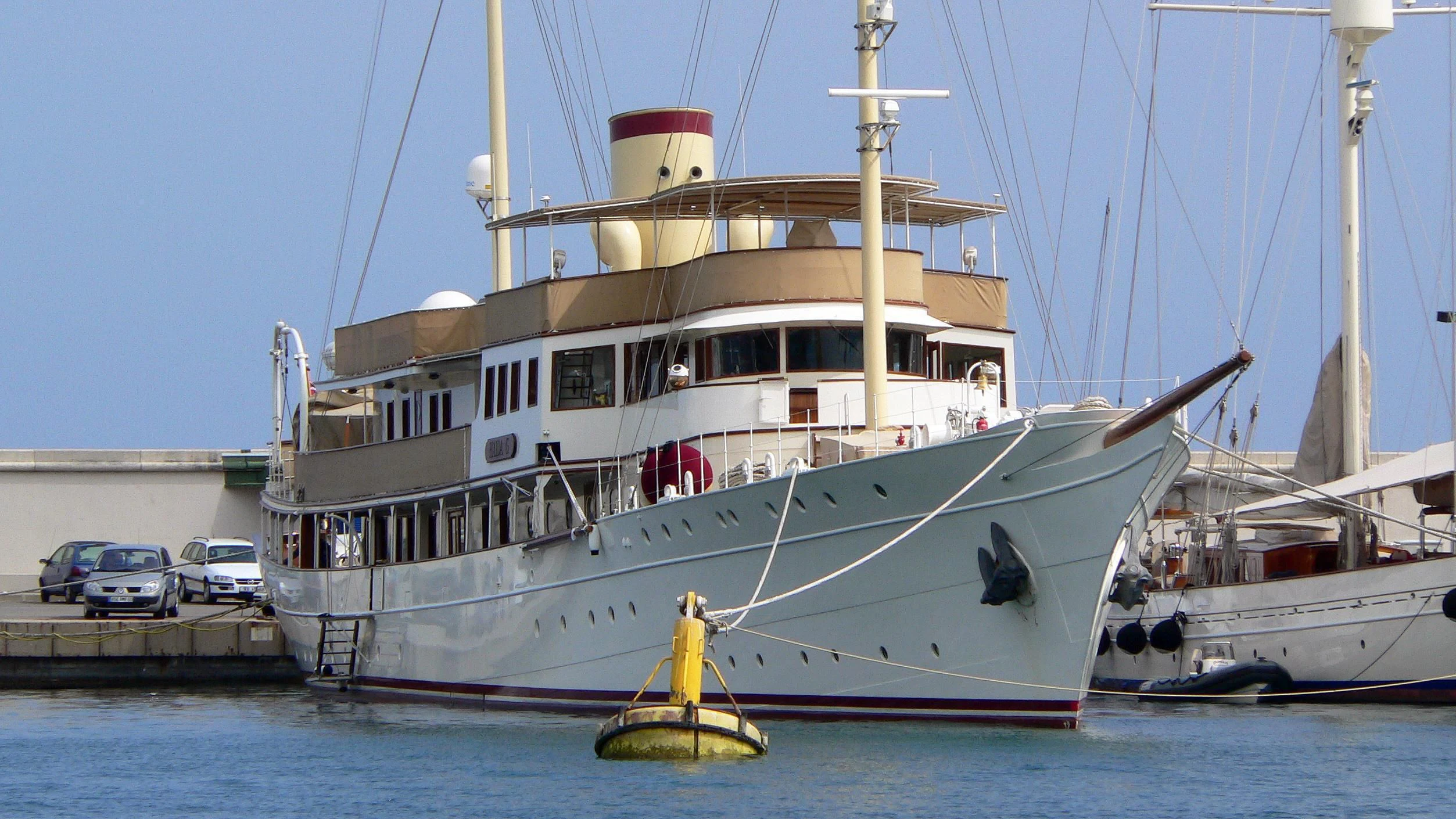 a large white boat with a yellow sail aboard HAIDA 1929 Yacht for Sale