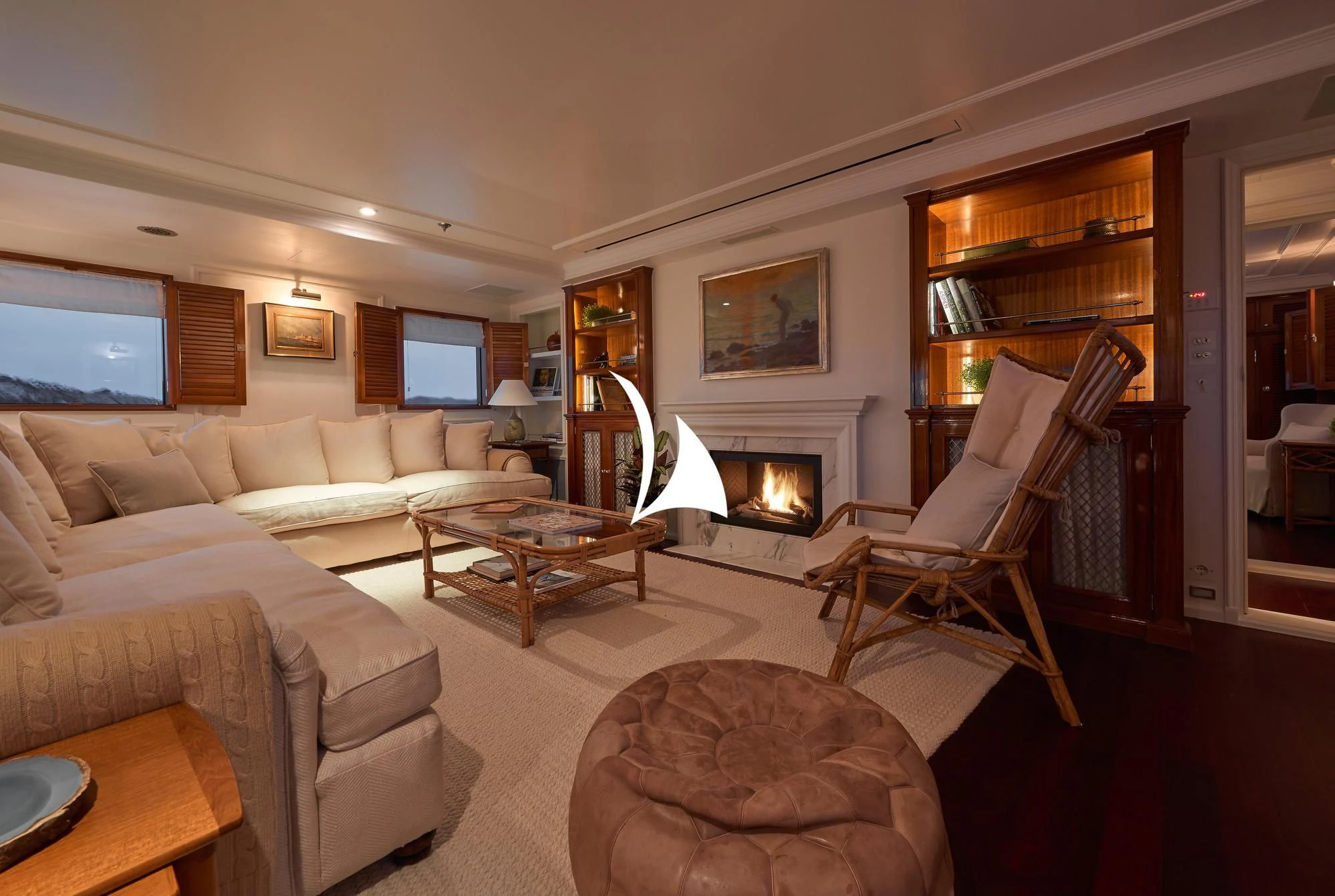 a living room with a fireplace aboard HAIDA 1929 Yacht for Sale