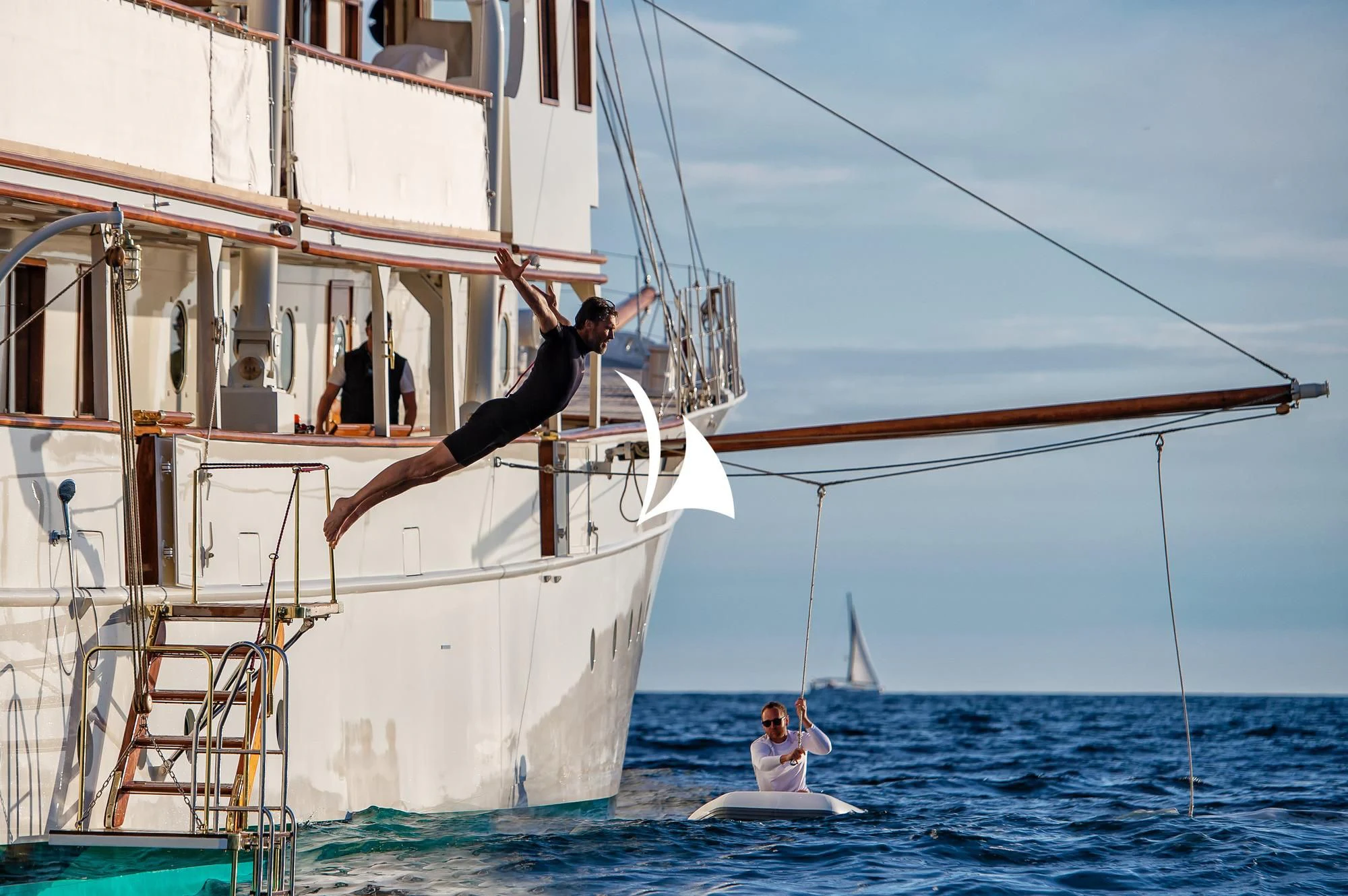a person jumping off a boat aboard HAIDA 1929 Yacht for Sale