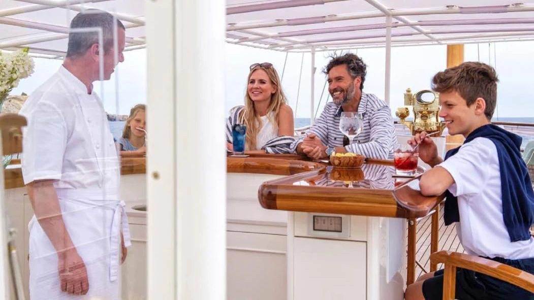 a group of people in a kitchen aboard HAIDA 1929 Yacht for Sale