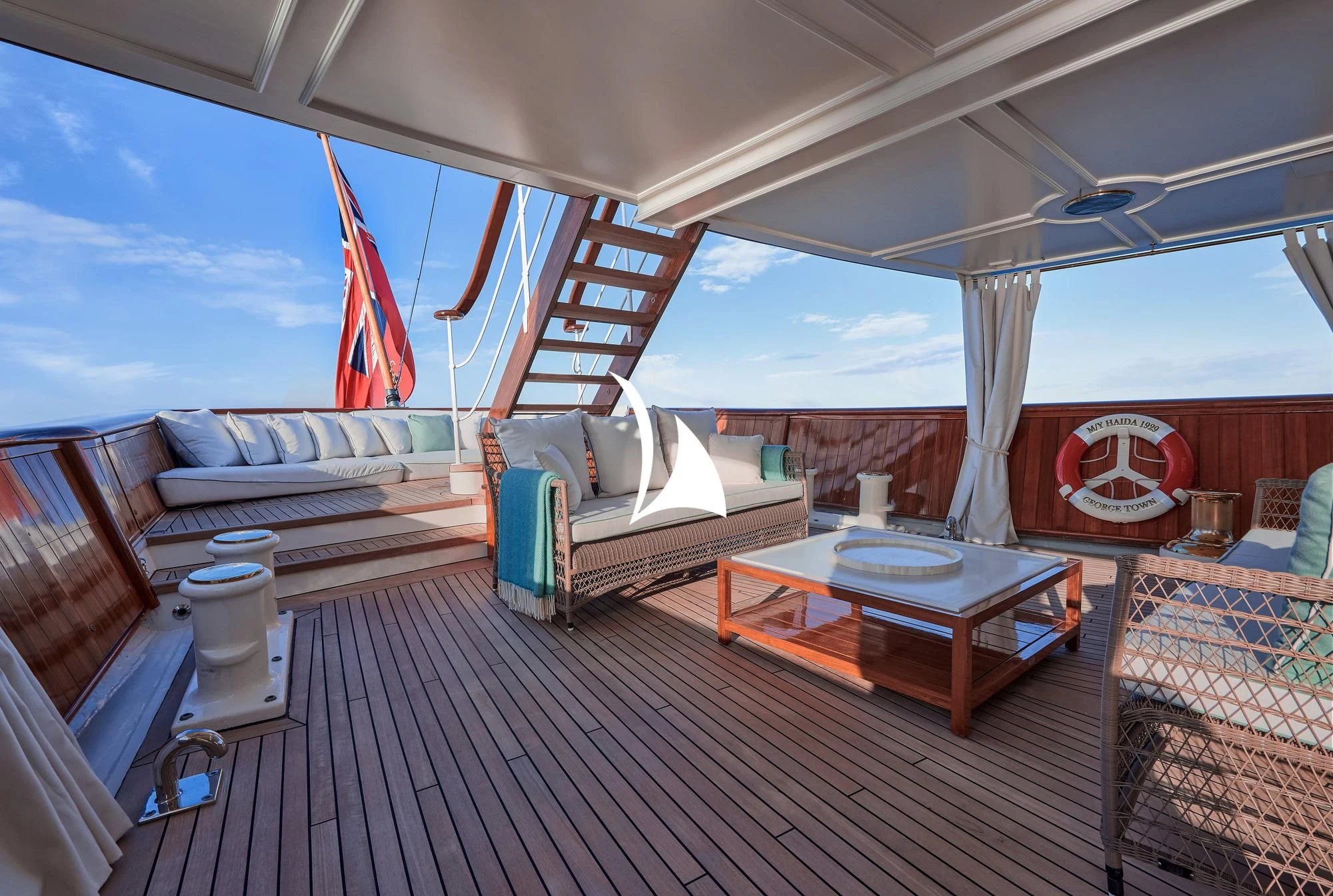 a room with a table and chairs aboard HAIDA 1929 Yacht for Sale