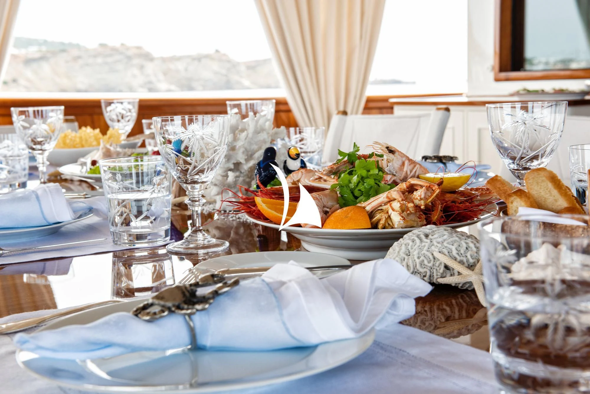 a table with food and glasses aboard HAIDA 1929 Yacht for Sale