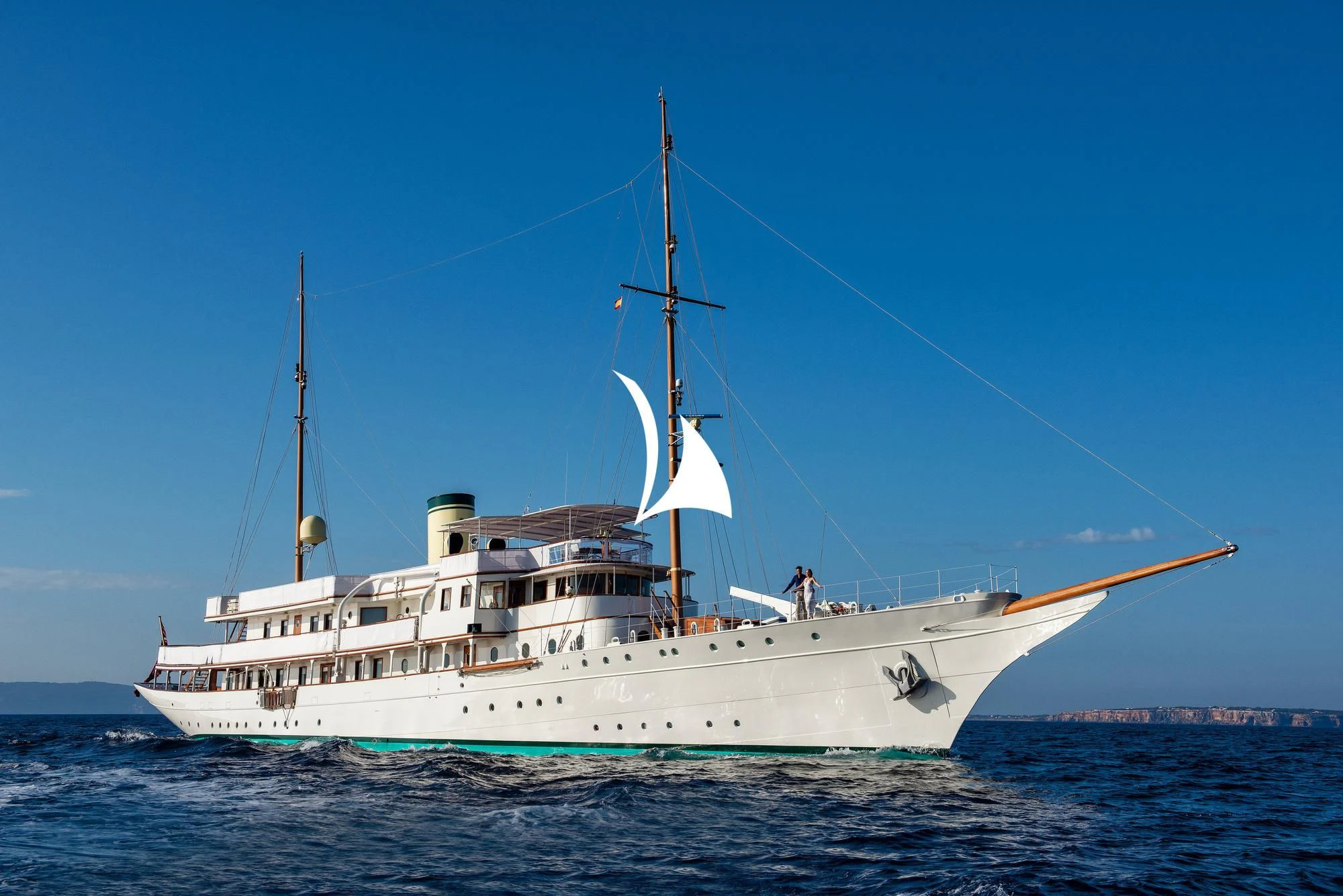 a large white boat in the water aboard HAIDA 1929 Yacht for Sale