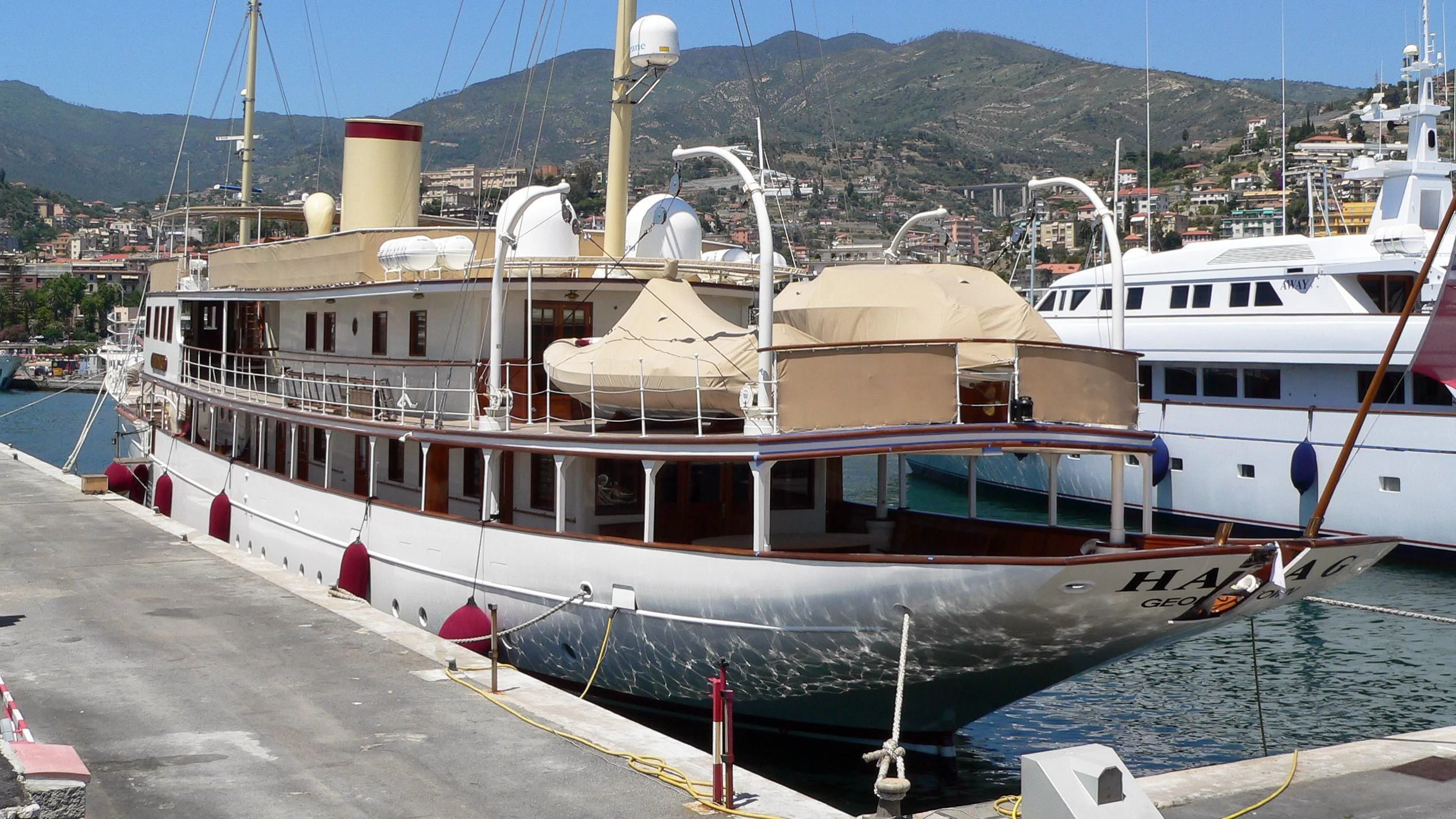 a couple of boats are parked in a harbor aboard HAIDA 1929 Yacht for Sale
