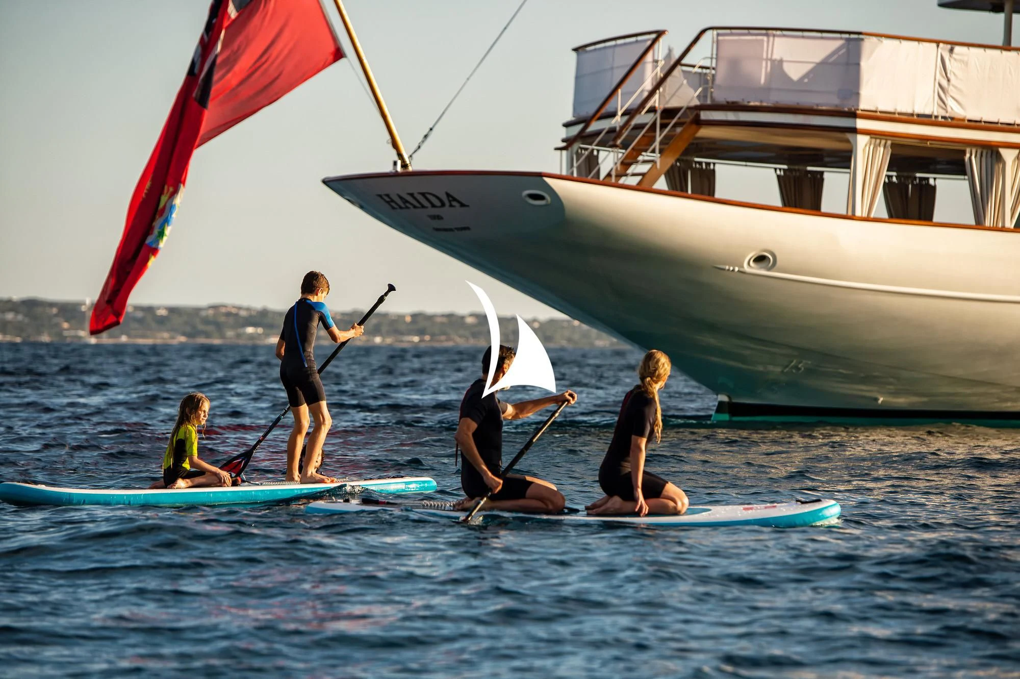a group of people on surfboards in the water aboard HAIDA 1929 Yacht for Sale