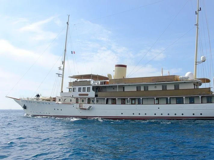 a large white boat in the water aboard HAIDA 1929 Yacht for Sale