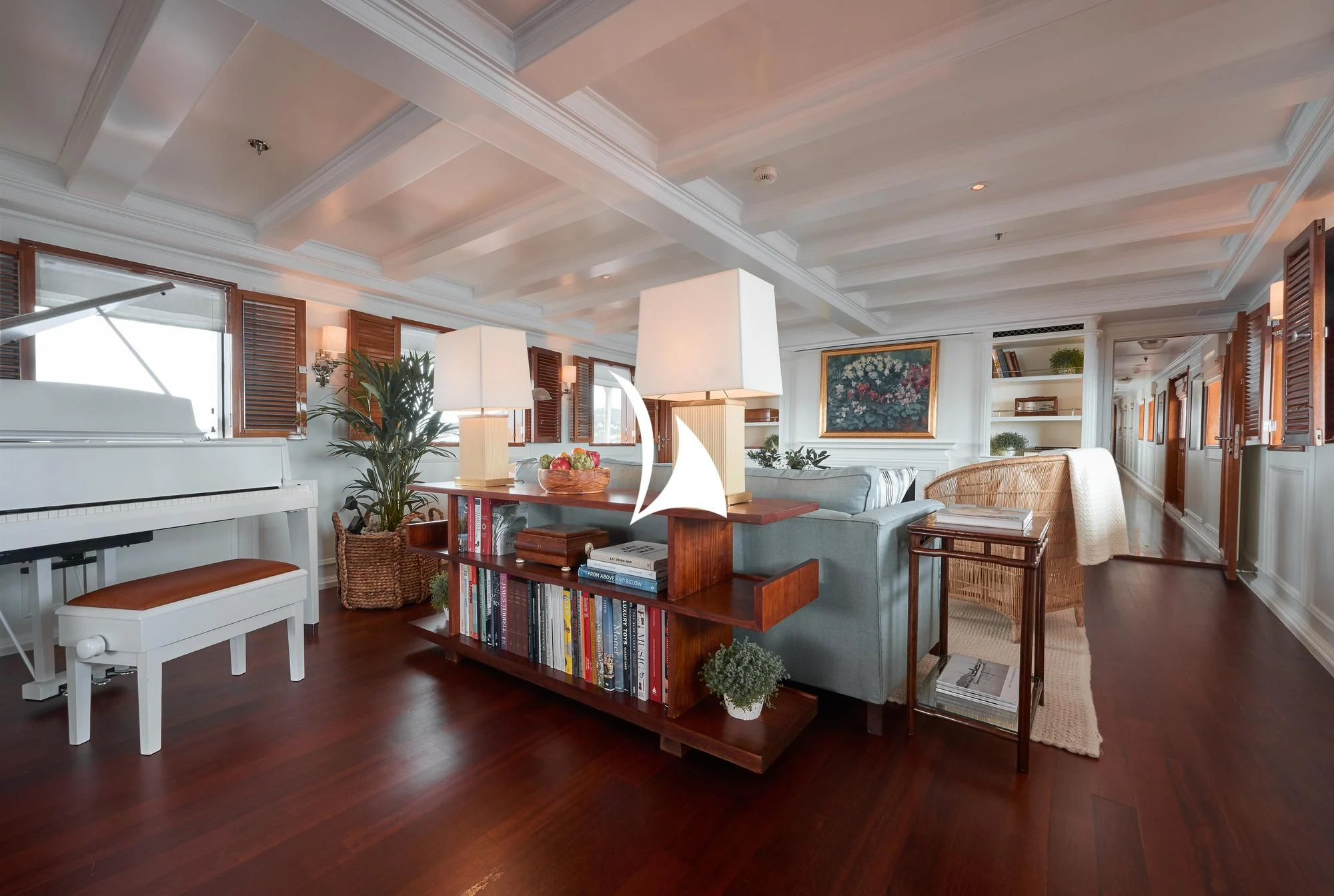 a living room with a couch and a table aboard HAIDA 1929 Yacht for Sale