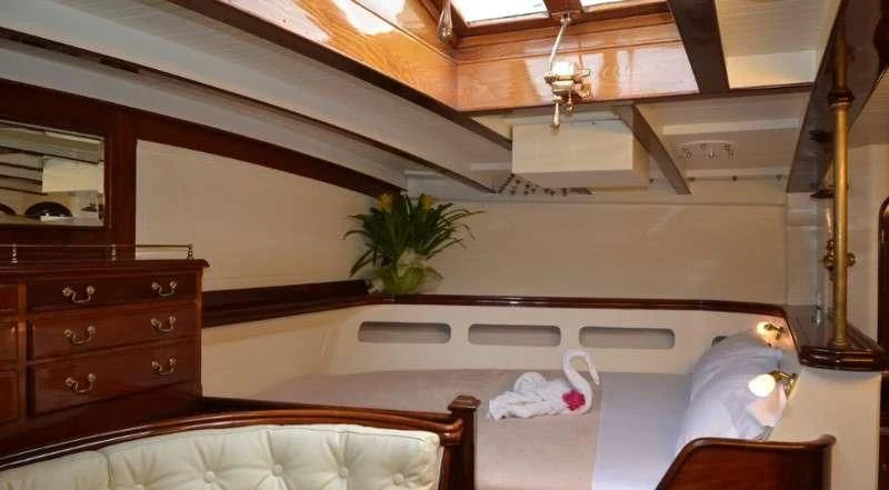a room with a bed and a desk aboard WHITEFIN Yacht for Sale