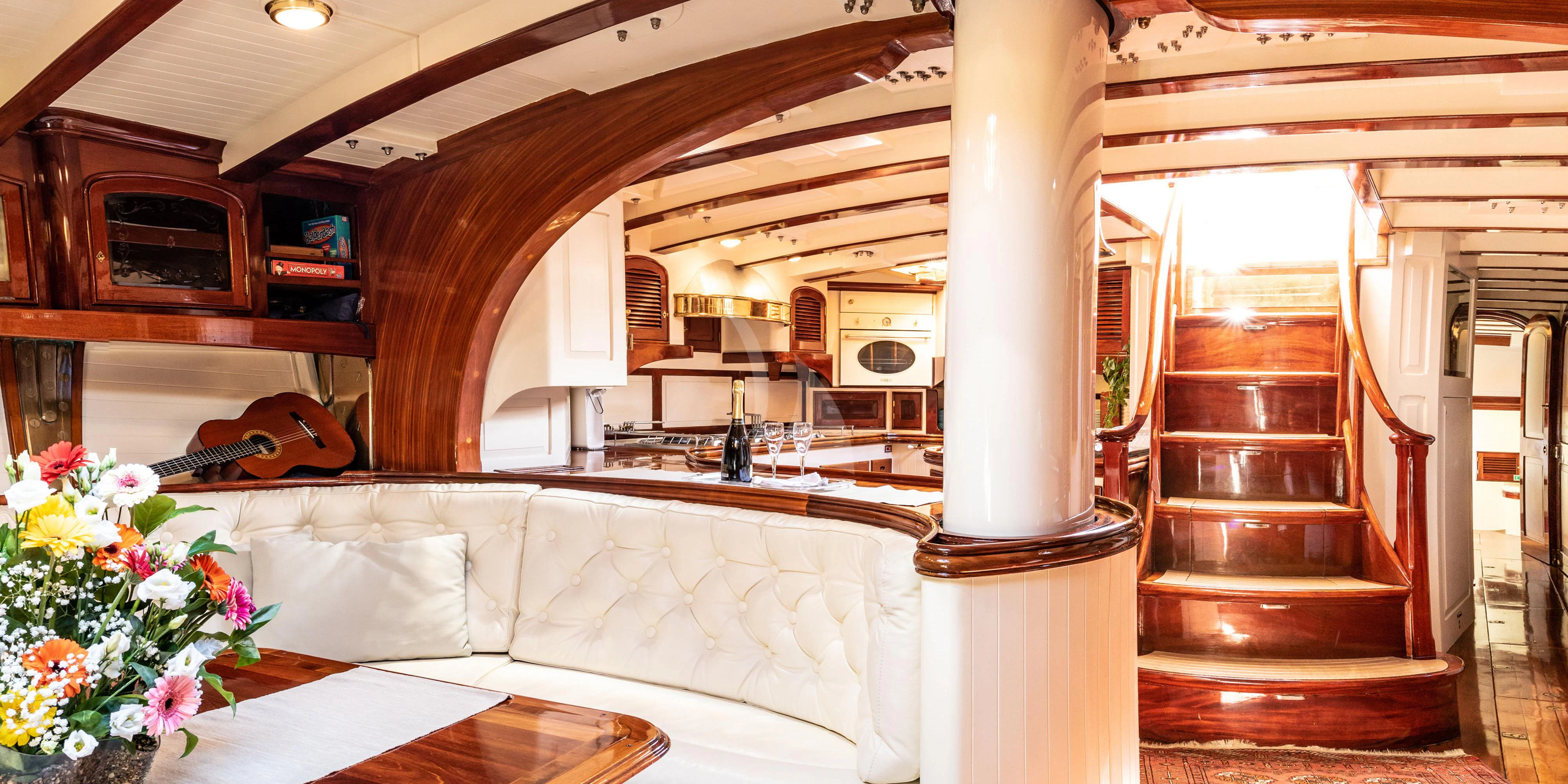 a living room with a couch and a table aboard WHITEFIN Yacht for Sale