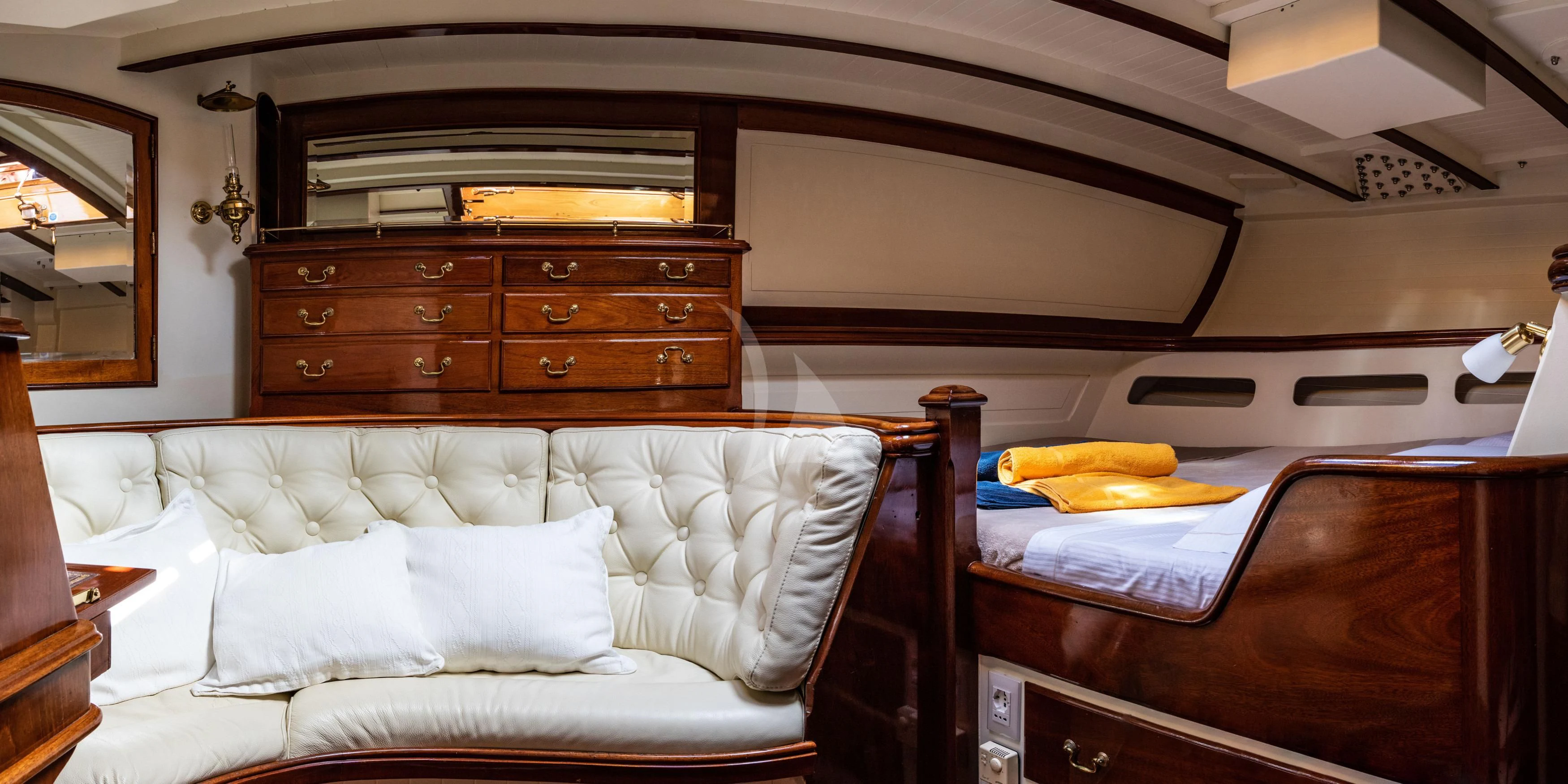 a room with a bed and a dresser aboard WHITEFIN Yacht for Sale