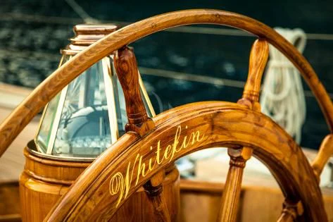 a wooden wheel with a large wheel aboard WHITEFIN Yacht for Sale