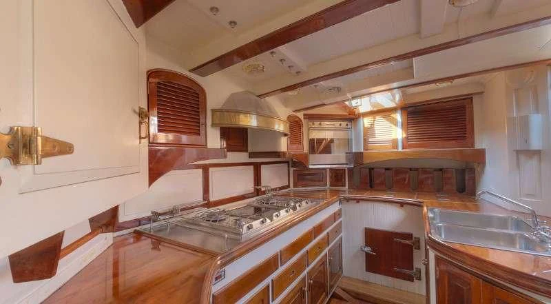 a kitchen with a stove and a sink aboard WHITEFIN Yacht for Sale