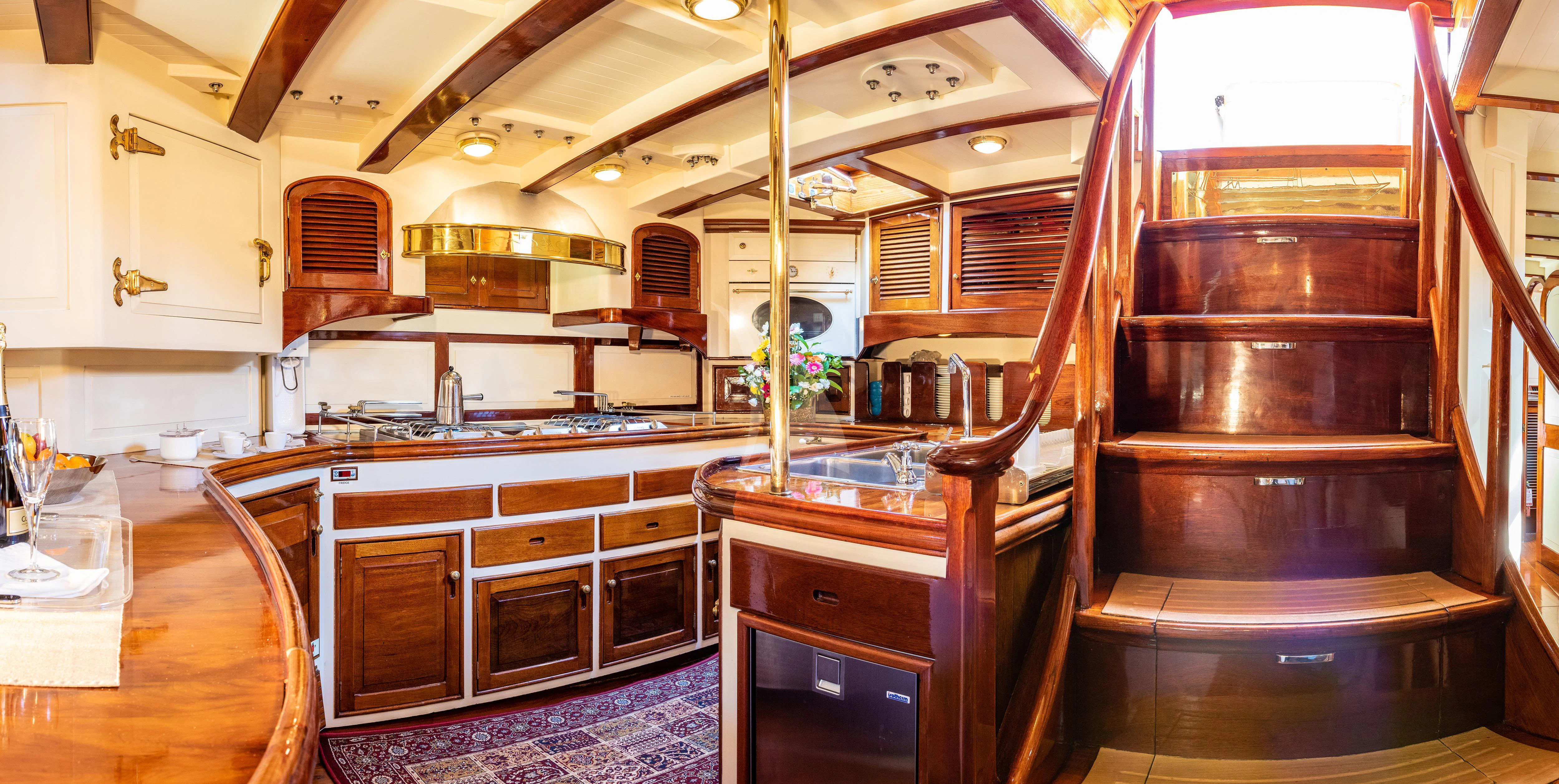 a kitchen with wooden cabinets aboard WHITEFIN Yacht for Sale