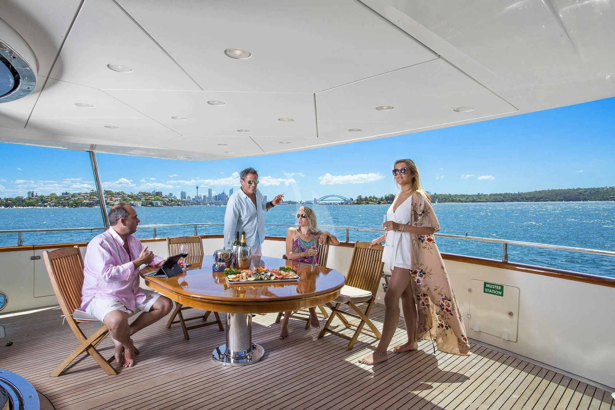 a group of people sitting around a table on a boat aboard LADY PAMELA Yacht for Sale
