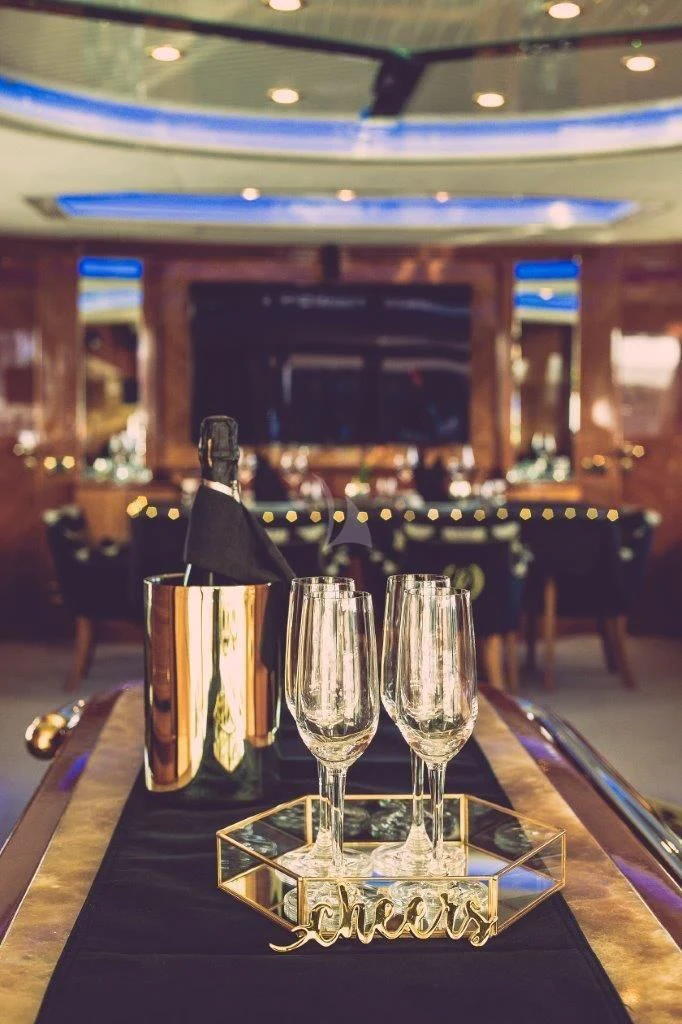 a group of wine glasses on a table aboard LADY PAMELA Yacht for Sale