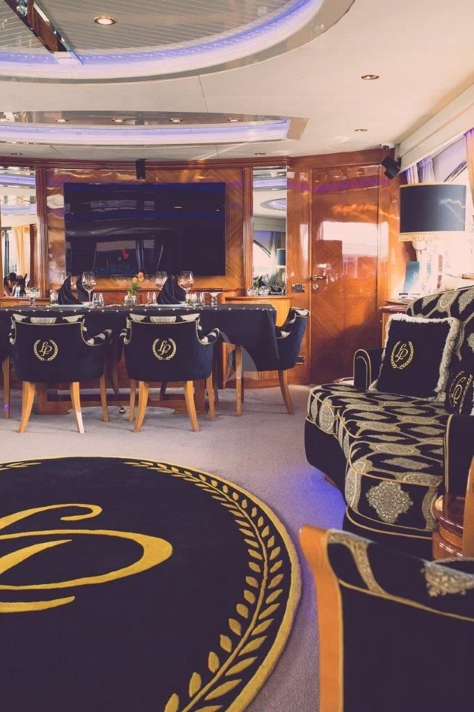 a room with a table and chairs aboard LADY PAMELA Yacht for Sale