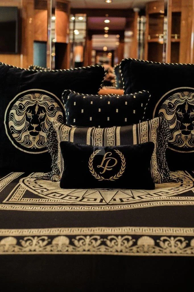 a black couch with a white and gold pattern aboard LADY PAMELA Yacht for Sale