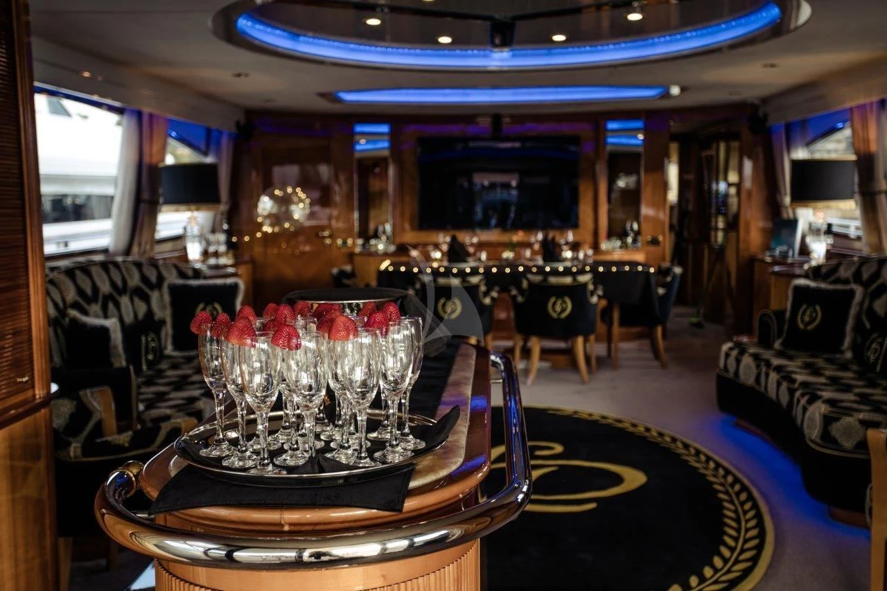 a table with wine glasses on it aboard LADY PAMELA Yacht for Sale