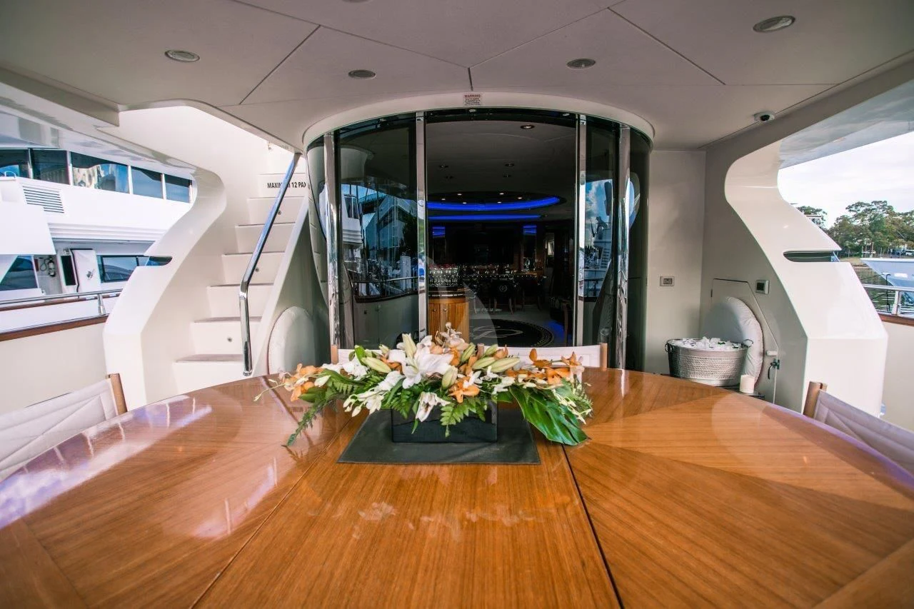 a table with flowers on it aboard LADY PAMELA Yacht for Sale