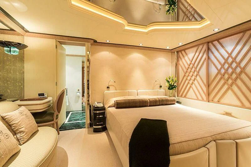 a room with a bed and a chair aboard LORETTA Yacht for Sale