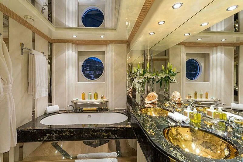 a bathroom with a sink and a large mirror aboard LORETTA Yacht for Sale