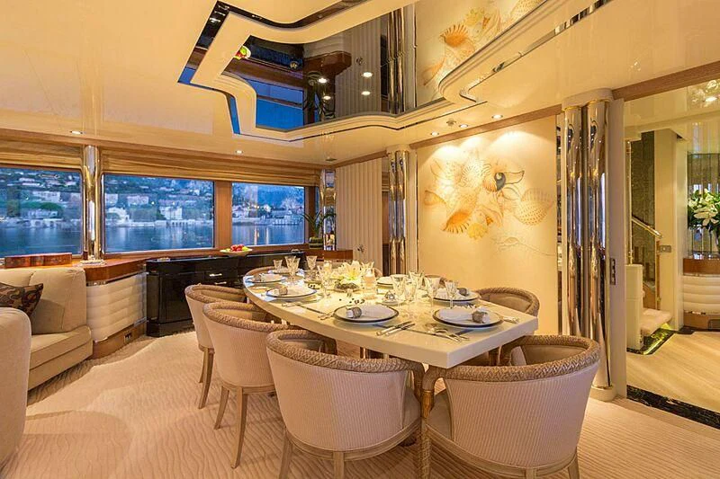 a dining table in a living room aboard LORETTA Yacht for Sale
