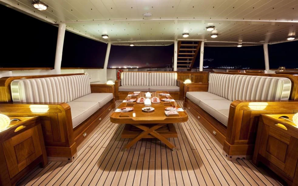 a room with couches and a table aboard STEEL Yacht for Sale