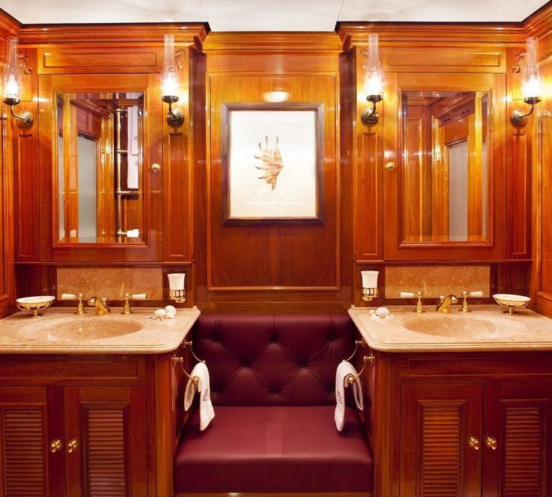 a bathroom with a red couch aboard STEEL Yacht for Sale